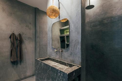 a bathroom with a stone sink and a mirror at Riad no37 in Marrakesh