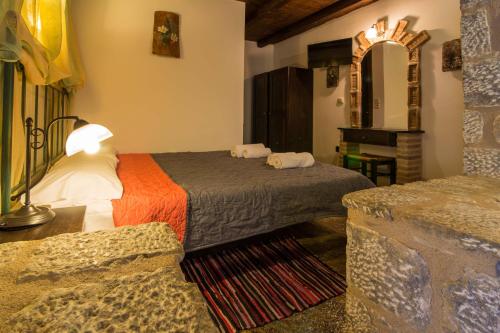 a hotel room with two beds and a couch at Psamathous Guesthouse in Pórto Káyio