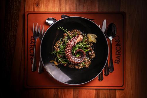 a pan of food on a table with a plate of food at Park Güell House Hotel in Talca