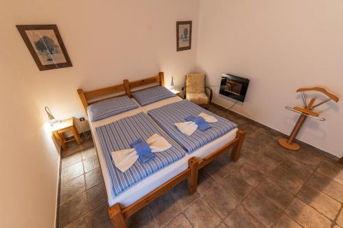 a bedroom with a bed with two towels on it at Apartmány Modrá Vrata in Stříbřec