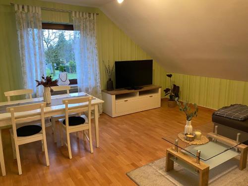 a living room with a table and a television at Naturpunkt in Isselburg-Anholt in Isselburg