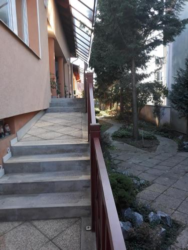 a set of stairs leading up to a building at Kenézy Lux Apartman Vendégház in Hajdúszoboszló