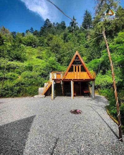 a small house on the side of a mountain at The Heavens Place in Nagar