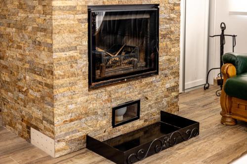 a living room with a brick fireplace at ForS Resort & Spa in Belgrade