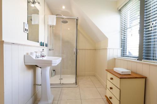 a bathroom with a sink and a shower at Escape Ordinary at Lough Erne GV - No.32 in Enniskillen