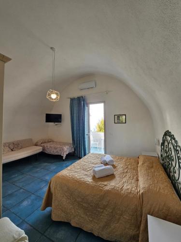 a bedroom with a bed in a room with a window at Residence Limoneto Ischia in Ischia