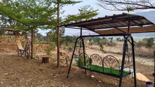 a metal bed with a canopy in a field at The Wai Hills MTDC Approved in Wai