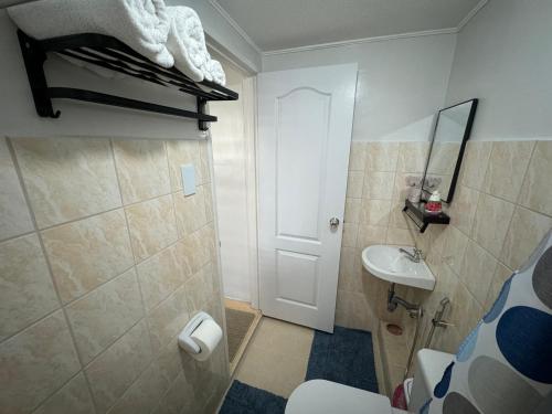 a small bathroom with a sink and a toilet at Condo in Pasig - One Oasis Staycation in Manila