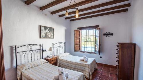 Posteľ alebo postele v izbe v ubytovaní Casa Rosario Almachar by Ruralidays