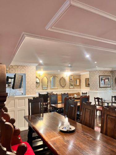 a dining room with a table and chairs at Rose Tor Hotel in Llandudno