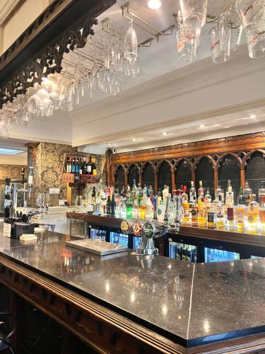 a bar with a lot of bottles of alcohol at Rose Tor Hotel in Llandudno