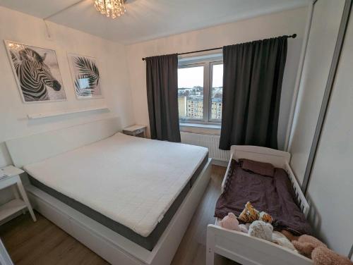a small bedroom with a bed and a window at Central apartment with a view in Växjö