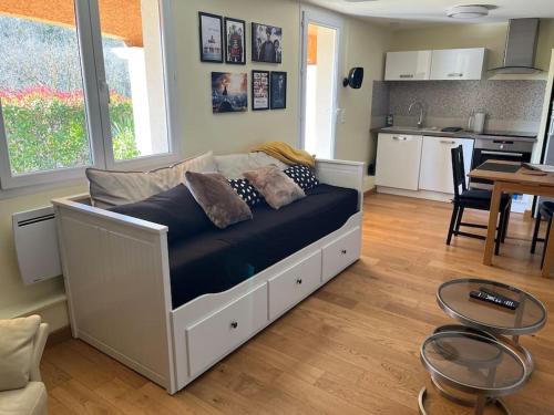 un canapé avec des coussins dessus dans un salon dans l'établissement Pierres Dorées : calme et détente à 2 pas de Lyon, à Charnay