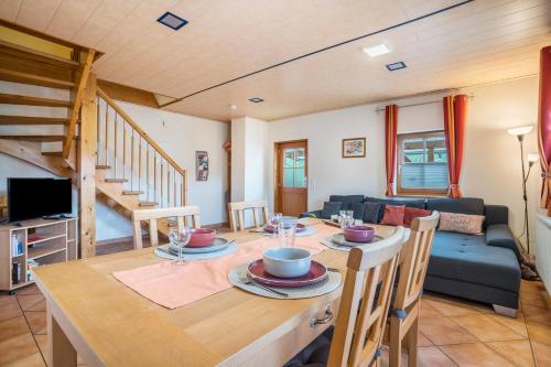 a dining room with a table and a couch at Ziegelhof in Schuttertal