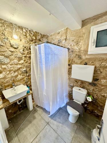a bathroom with a toilet and a sink at Rocksecret Edge in Kalamata