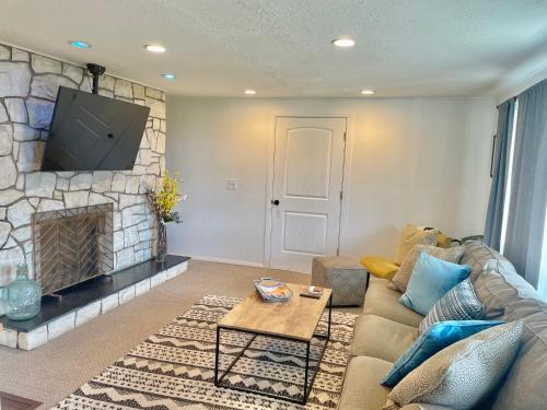 a living room with a couch and a fireplace at City light views getaway close to top ski resorts in Salt Lake City