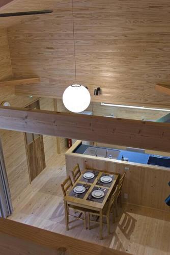 an overhead view of a table and chairs in a room at Noto cottage Hinoki no ie - Onsen in a cypress bathtub in Shika