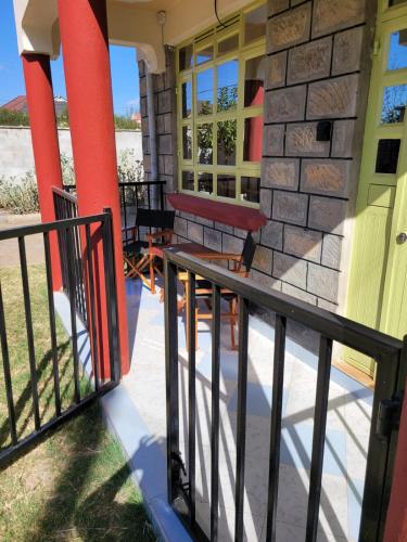 a porch of a house with a bench on it at Gloria house in Syokimau