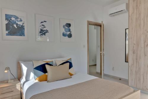 a bedroom with a bed with pillows on it at Phaedrus Living: City Center Residences Emerald in Nicosia