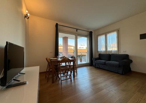 ein Wohnzimmer mit einem Tisch und einem Sofa in der Unterkunft Maison Linda - Ponte Milvio Apartment in Rom