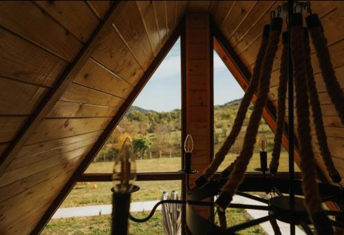 a view from the inside of a tent with a window at La Poalele Vulcanilor in Densuş
