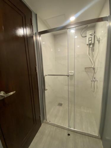 a shower with a glass door in a bathroom at Near AYALA-Charming Studio with Balcony&Great View in Cebu City