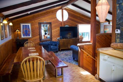 a living room with a table and a television at Yosemite Bug Rustic Mountain Resort in Midpines