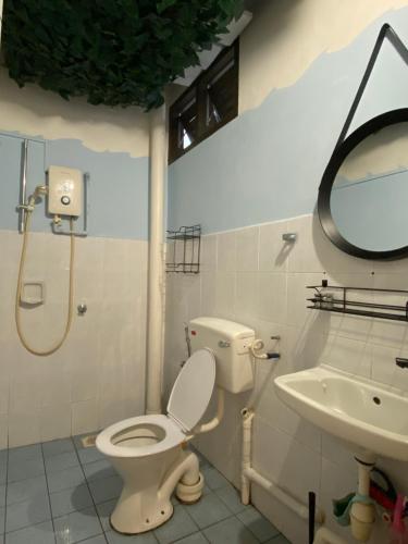 a bathroom with a toilet and a sink at Two Sip Home in George Town