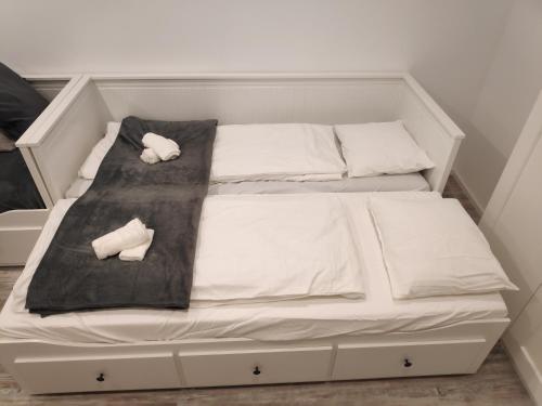 a white bed with two pillows on it at Modernes Studio im Zentrum 4 Personen in Wiener Neustadt
