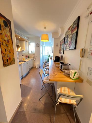 a kitchen with a long table with chairs in it at B&B Birba in Rome