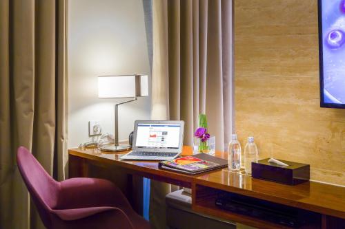 a desk with a laptop computer on top of it at Liberty Central Saigon Riverside Hotel in Ho Chi Minh City