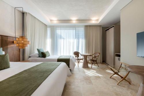 um quarto de hotel com duas camas e uma mesa em Oz Hotel Cartagena em Cartagena das Índias