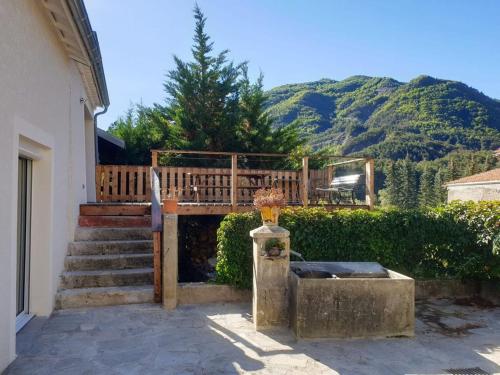 a deck with a bench and stairs with mountains in the background at Maison de 3 chambres avec jardin clos a Chateauneuf d'Oze 