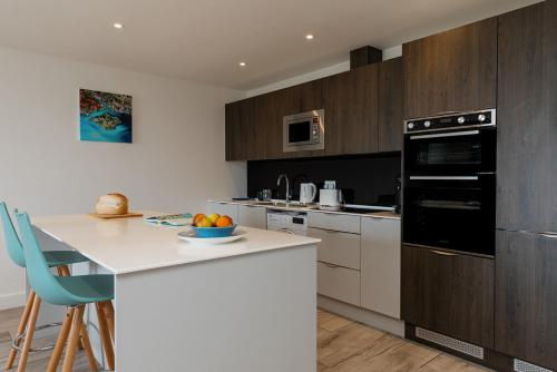 a kitchen with a counter with a bowl of fruit at Blue Horizon in Sandown