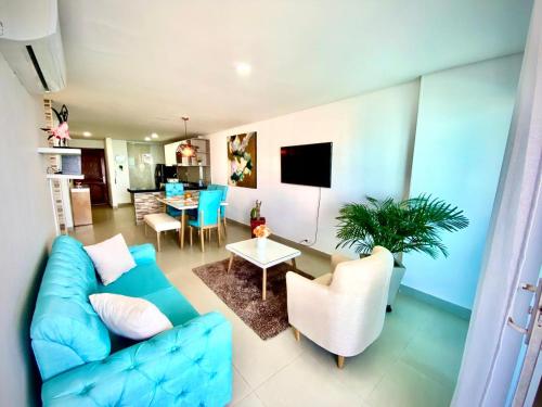 a living room with a blue couch and a table at Torres del lago Pegasus Group Cartagena in Cartagena de Indias