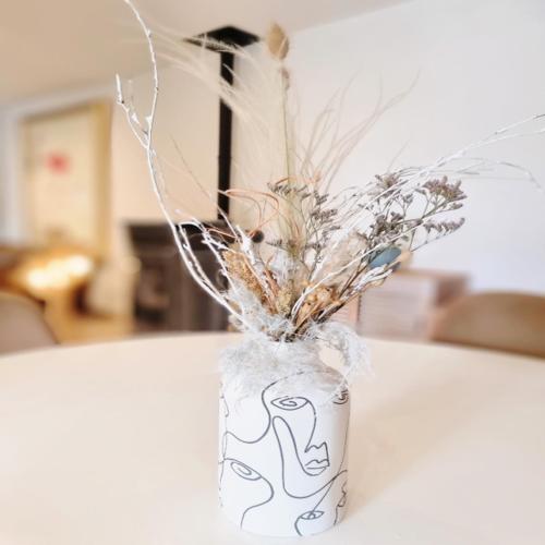 a vase filled with dried flowers on a table at Villa OASIS en Provence Luberon Pierrevert in Pierrevert