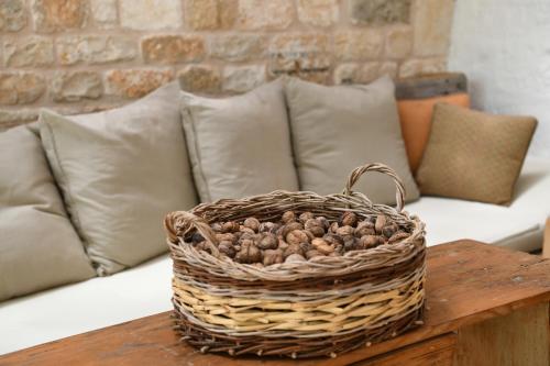 a basket of nuts sitting on a table on a couch at B&B Masseria Piccola in Cisternino