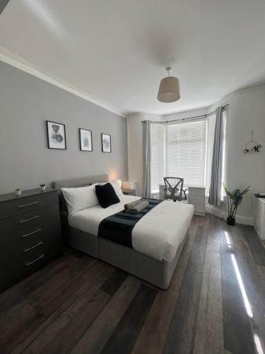 a bedroom with a large bed and a large window at No. 73 in Liverpool