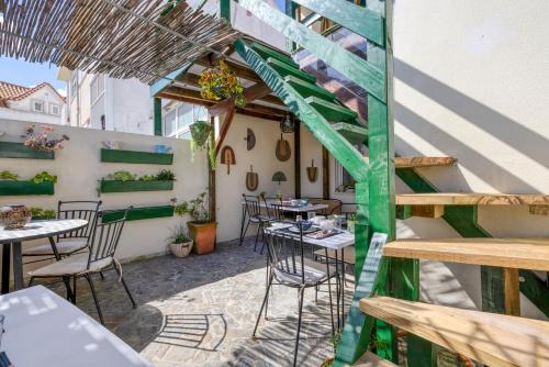 a patio with tables and chairs in a building at Pillows Peniche B&B in Peniche