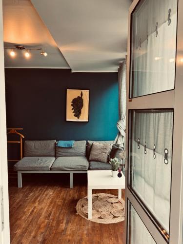 a living room with a couch and a table at Studio indépendant et calme avec Jacuzzi à Lille in Lille