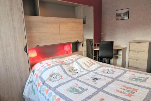 une chambre avec un lit, un bureau et une chaise dans l'établissement Appartement VUE MER avec terrasse et WIFI à PERROS-GUIREC - Réf 828, à Perros-Guirec