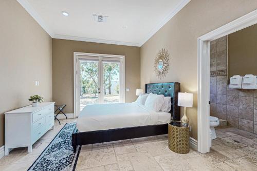 a bedroom with a king sized bed and a bathroom at Alta Vista Villa in Vista
