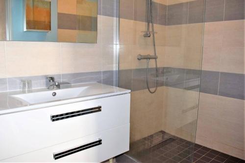 uma casa de banho com um lavatório e um chuveiro em Appartement 2 chambres avec superbe vue mer sur la plage de Trestrignel à PERROS-GUIREC - Réf 834 em Perros-Guirec