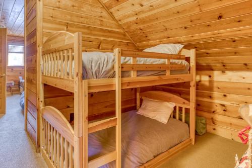 a bedroom with two bunk beds in a log cabin at Sno-Bird #10 in Government Camp