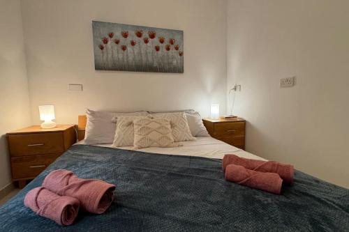 a bedroom with a bed with two towels on it at Modern Seaview-2 min from Beach in Sliema