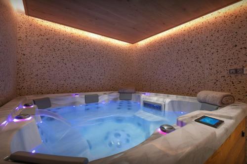 a jacuzzi tub with lights in a room at Chalet Ours Rouge - OVO Network in Le Grand-Bornand