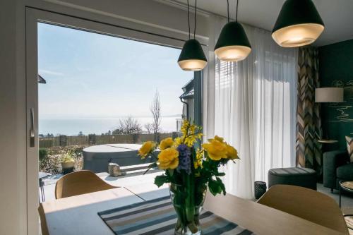 a vase of yellow flowers on a table in a room at EMMY Ház in Badacsonytomaj