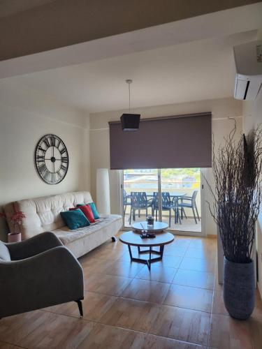 a living room with a couch and a table at Maestro III Apartment in Larnaca