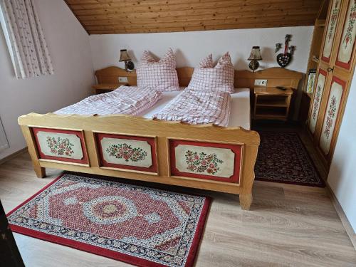 a doll house bedroom with two beds and a rug at Am Wehrastrand App 5 in Todtmoos