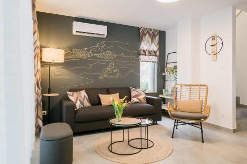 a living room with a couch and a table at EMMY Ház in Badacsonytomaj